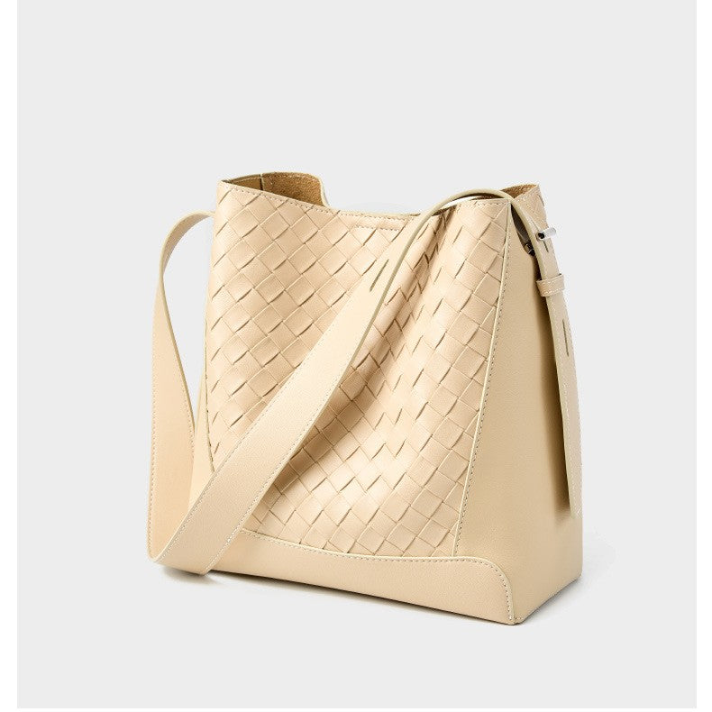 The beige white woven tote bucket hobo handbag is made of soft genuine leather, with an adjustable crossbody sling strap.