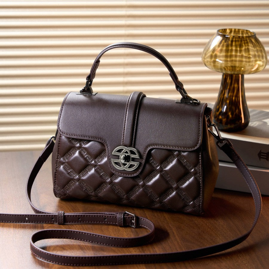 This is the brown mini top handle crossbody bag, it has the adjustable sling strap.