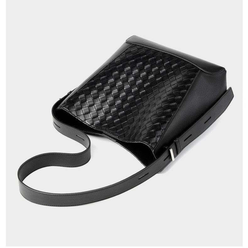 This is the flat display of the women's black woven crossbody tote bag. It is made of high quality genuine leather and has an adjustable strap.