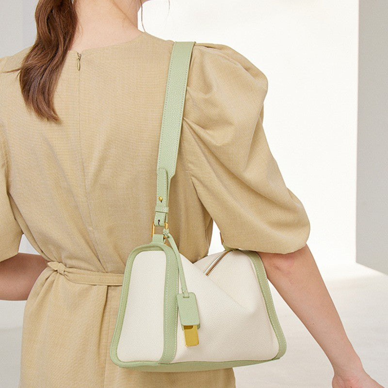The mint two - tone boston hobo shoulder bag is in a pillow shape.