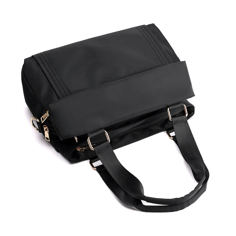 The black top handle bag has a replacement crossbody sling strap, suitable for work and everyday use.