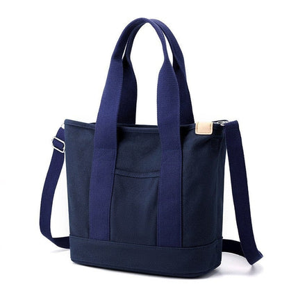 The best medium/large blue zipper canvas tote bag has soft handles and crossbody strap, suitable for students.
