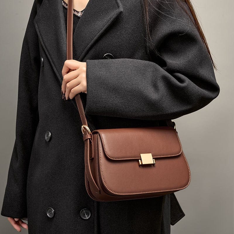 The brown crossbody square bag is made of soft genuine leather, and has replacement should strap.