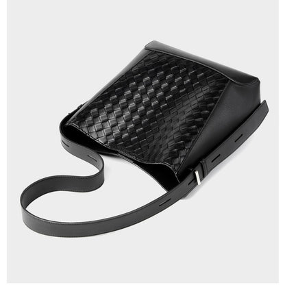This is the flat display of the women's black woven crossbody tote bag. It is made of high quality genuine leather and has an adjustable strap.