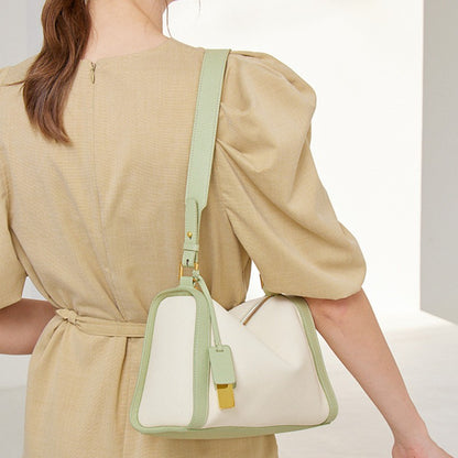 The mint two - tone boston hobo shoulder bag is in a pillow shape.