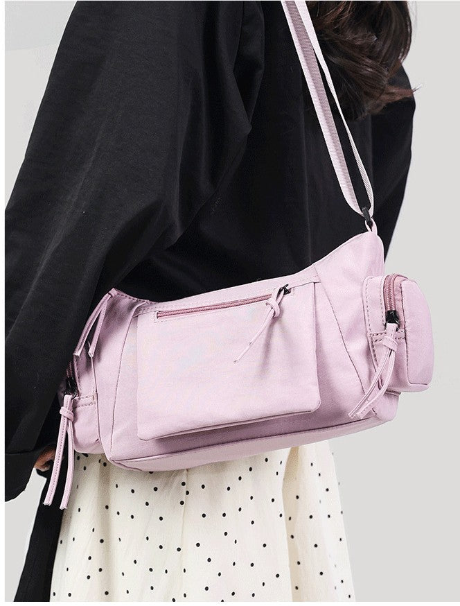 This is a showcase of how the belluova pink crossbody shoulder bag looks when worn. 