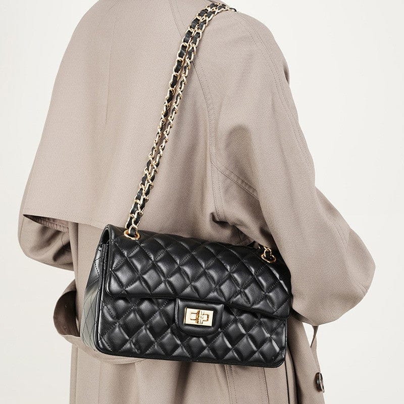 The black crossbody shoulder bag have gold chain strap and hardware.