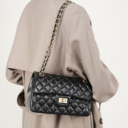 The black crossbody shoulder bag have gold chain strap and hardware.