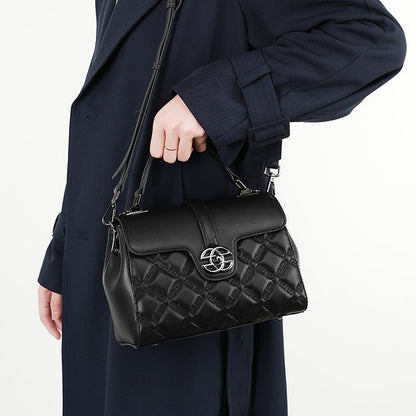 The black crossbody bag, which has a top handle, a flap design, an embossed pattern and an adjustable sling strap, can be handheld or carried over the shoulder or crossbody.
